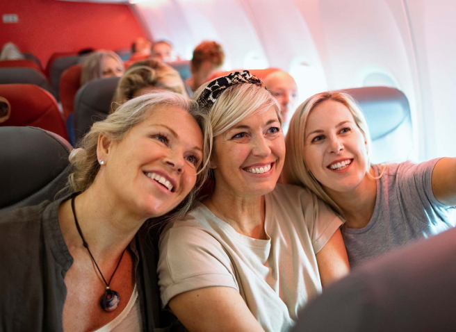 Three women taking a selfie on a plane