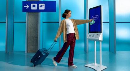 Two women hugging and a third women looking at them and smiling