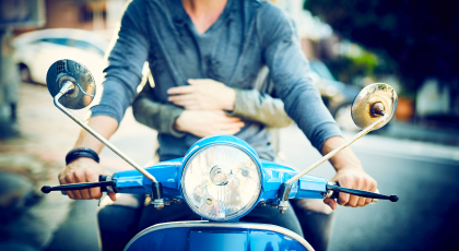 Two people on a scooter - close up detail